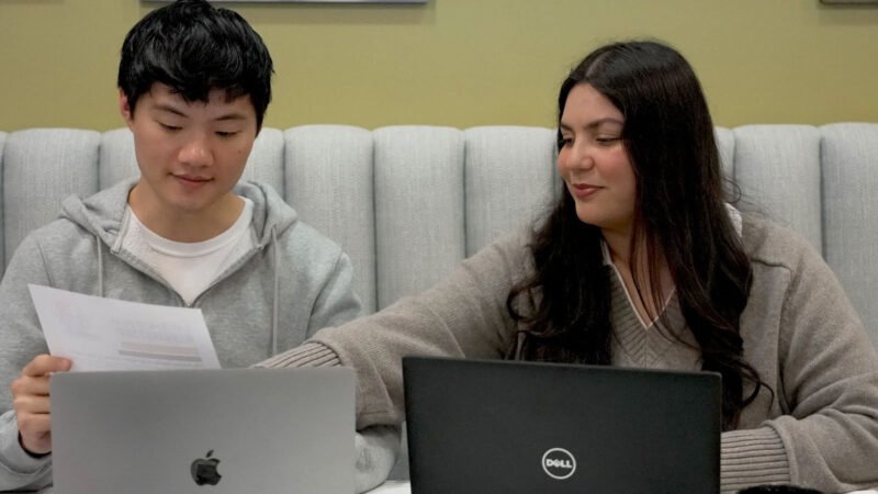 Accelerate Workshop instructor assisting a business owner with a lesson.