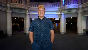 Owner standing in the beautiful Saban Theater.