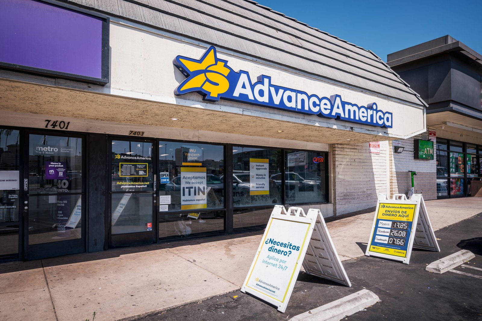 Advance America – exterior storefront of the Advance America branch with sidewalk signs out front.