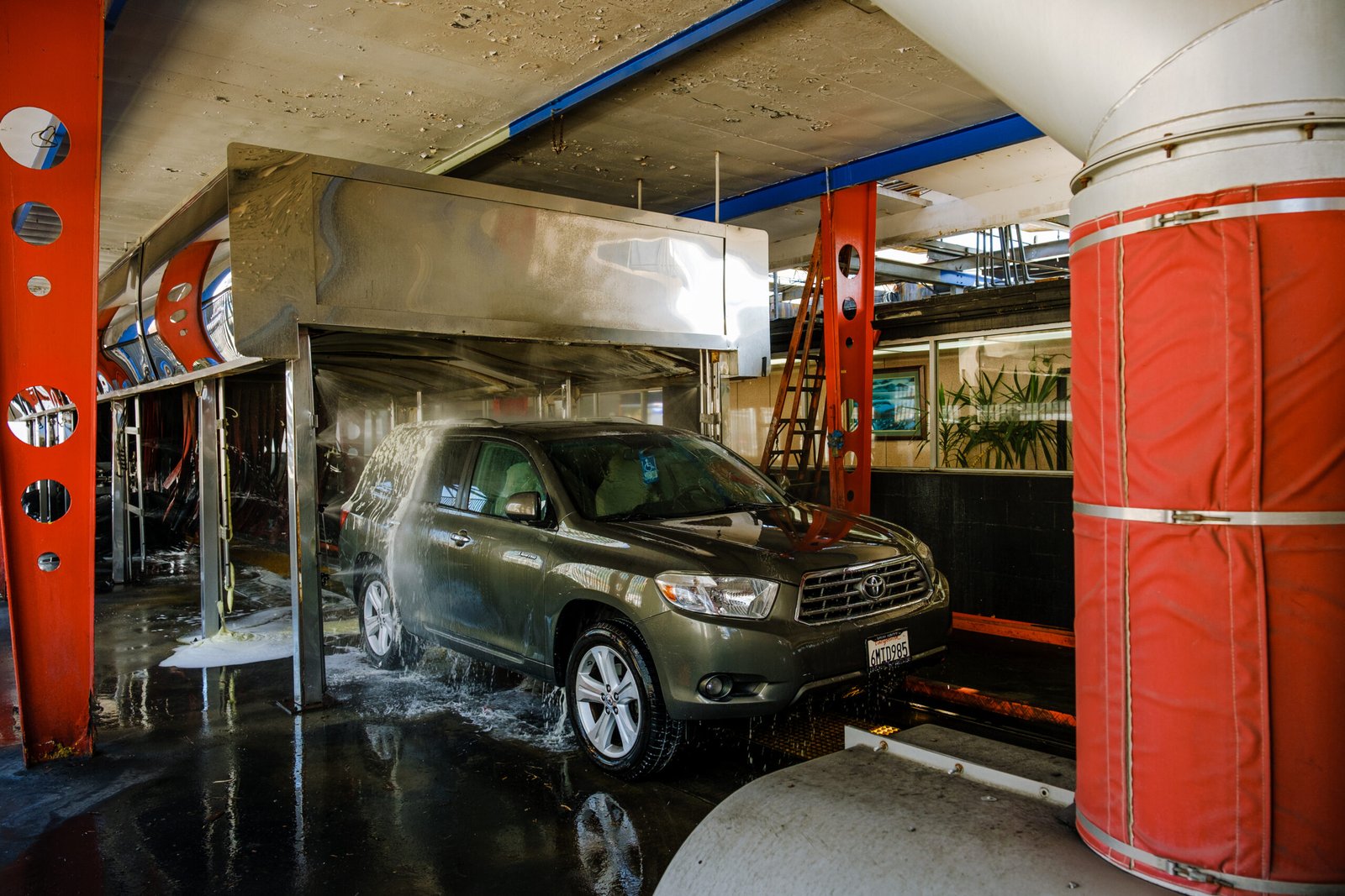 Valley Car Wash – SUV moving through the soapy brushes of the automatic car wash tunnel.