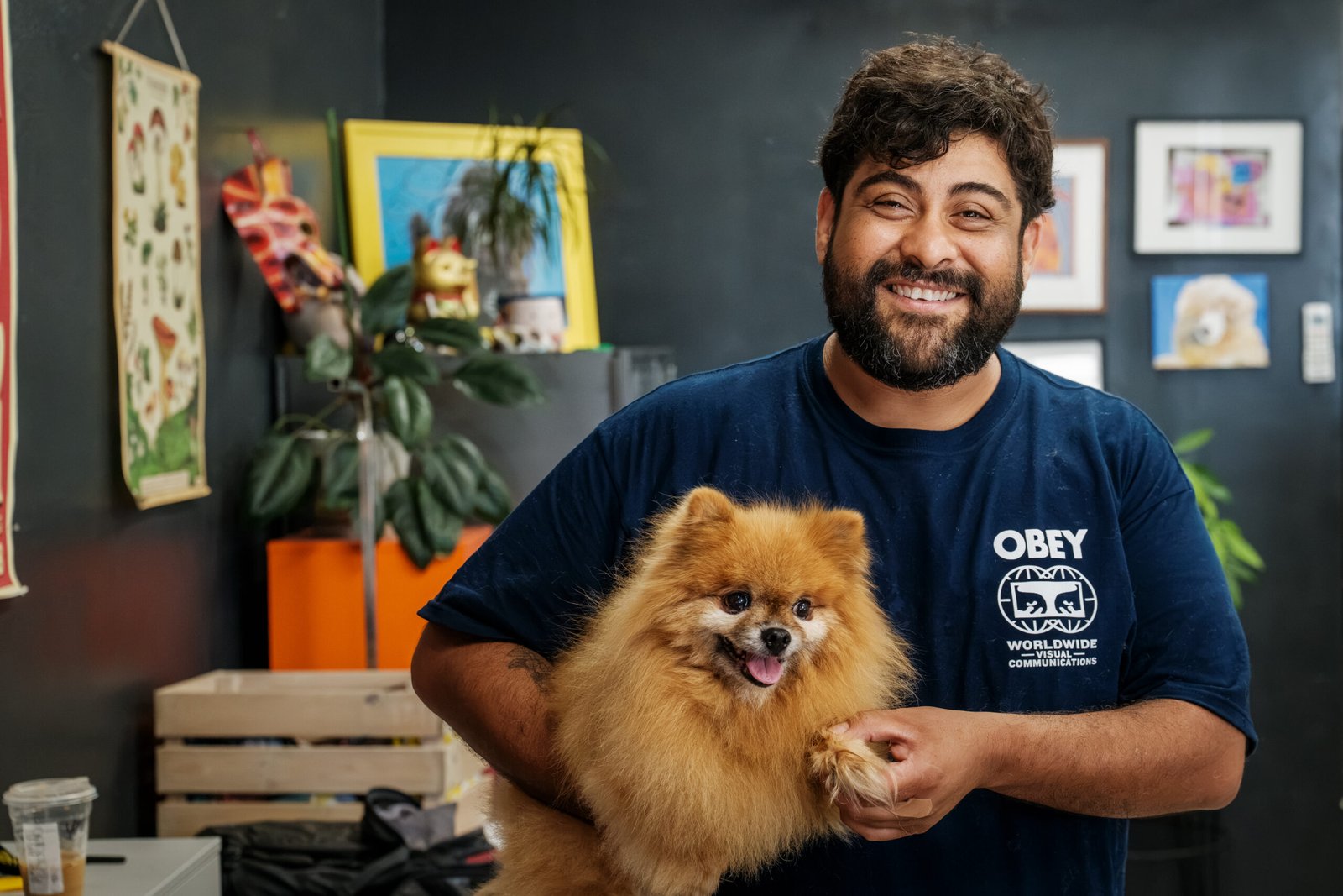 Roxy's Pooch Parlour – groomer holding a freshly groomed Pomeranian in the dog grooming shop.