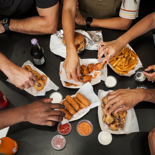Photo of people eating wings from Hot Wings Paradise